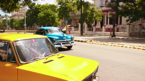 La-Habana,-Cuba,-Septiembre-De-2019:-Autos-Brillantes-Que-Circulan-Por-Una-Carretera-Local-En-Cámara-Lenta