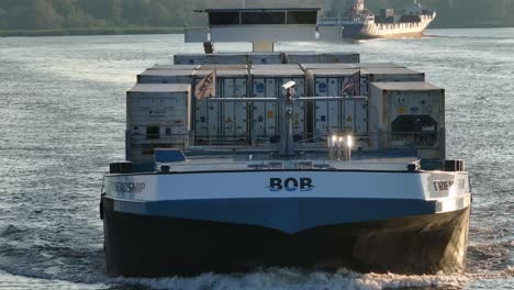 Drone-Slow-Closeup-dutch-ship-Friendship-reefer-vessel,-calm-waters-surrounding