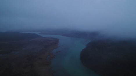 Moody-drone-footage-flying-though-fog-over-the-Naknek-River-in-King-Salmon,-Alaska