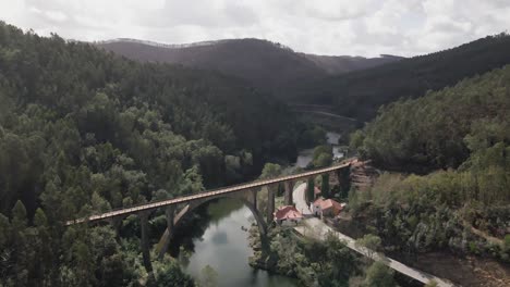 Aerial-view-of-a-stone-bridge-going-across-a-river