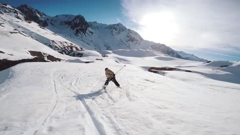 following-view-of-a-young-man-skier-skiing-doing-a-jump-trick-in-a-french-ski-resort