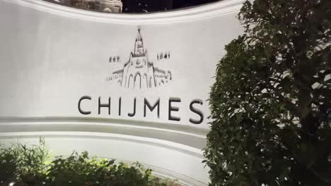 Cinematic-pan-shot-capturing-the-signage-on-the-wall-of-the-historic-building-chijmes-located-at-victoria-street-at-downtown-central-Singapore-at-night