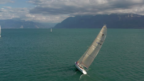 Aerial-of-boat-sailing-on-a-vast-and-beautiful-lake-in-summer