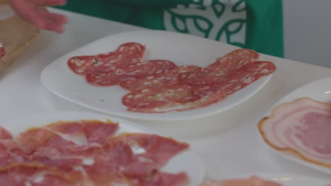 Un-Plato-Que-Presenta-Una-Variedad-De-Embutidos,-Listos-Para-Agregarse-A-Una-Tabla-De-Charcutería.