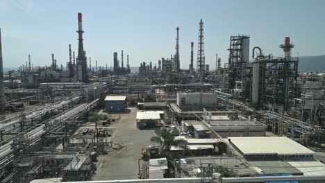 Aerial-footage-of-a-large-scale-Oil-refinery-with-smoke-stacks-and-petroleum-storage-tanks