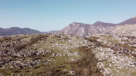 Aerial-landscape-view-above-an-italian-village,-surrounded-by-mountains