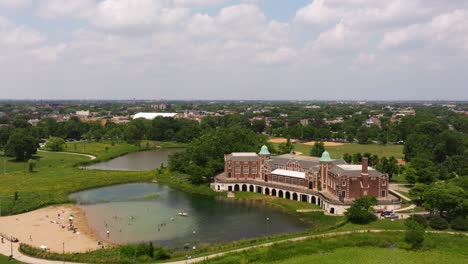 Establishing-Aerial-View-Above-Humboldt-Park-Lagoon-and-Fieldhouse-in-Chicago,-Illinois