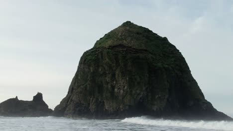 A-low-moving-shot-of-Haystack-rock-on-Cannon-Beach,-Oregon