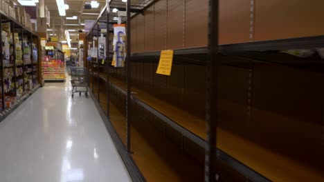 4K-STABILIZED:-Walking-down-an-empty-toilet-paper-aisle-with-"ATTENTION"-signs-in-a-grocery-store-during-the-coronavirus-outbreak