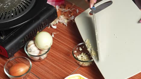 Woman-Putting-Sliced-Onions-Into-Bowl