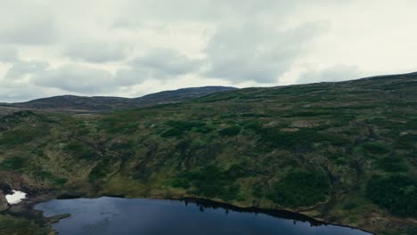 A-Breathtaking-View-of-the-Pristine-Inner-Kjøåkertjønna-Lake-in-Osen,-Trøndelag,-Norway---Pan-Up-Shot