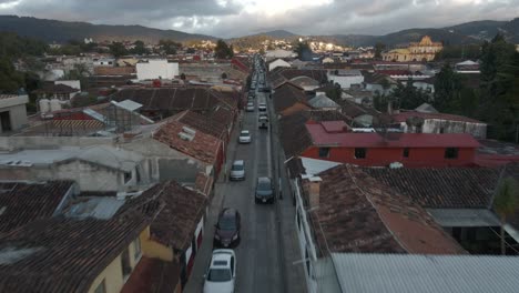 San-Cristobal-de-las-Casas-town-in-Mexico,-aerial-over-main-road-and-houses