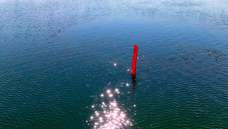 Red-Delayed-Surface-Marker-Buoy-For-Divers-In-Glistening-Lake-Water-In-Latvia