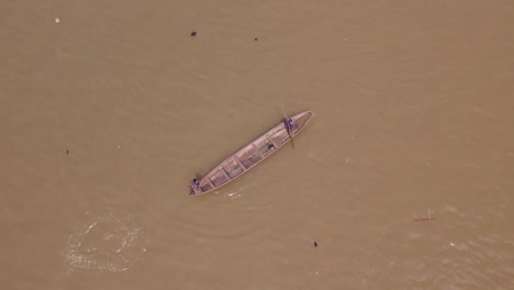 Makoko-Community,-Lagos,-Nigeria---30-June-2024:-Drone-view-of-fishermen-casting-a-net-into-the-Lagoon-in-Makoko-community