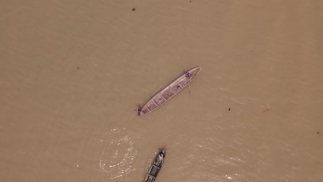 Makoko-Community,-Lagos,-Nigeria---30-June-2024:-Drone-view-of-fishermen-casting-a-net-into-the-Lagoon-in-Makoko-community