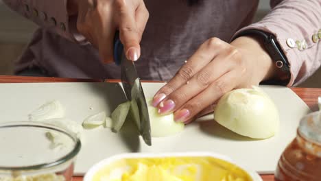 Woman-Slicing-Onions-On-Cutting-Board-For-Preparing-Make-Asian-Barbeque