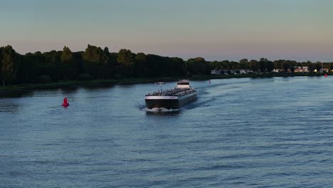 Wide-low-aerial-of-tanker-ship-Jobskade-on-calm-river-in-Netherlands