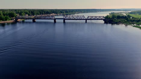 Kayak-Boat-On-Tranquil-River-Near-Lielupe-Railroad-Bridge-In-Latvia