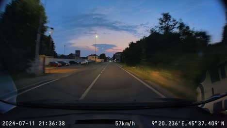 POV-dash-cam-footage-from-car-driving-through-Italian-town-at-dusk