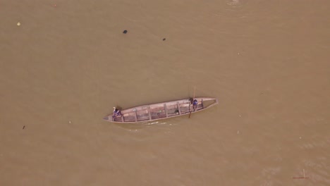 Makoko-Community,-Lagos,-Nigeria---30-June-2024:-Drone-view-of-fishermen-casting-a-net-into-the-Lagoon-in-Makoko-community