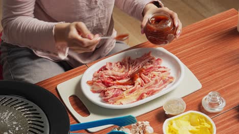 Hands-Adding-And-Brushing-Spice-To-Beef-Slice-For-Prepare-Cooking-Asian-BBQ-Food-Style