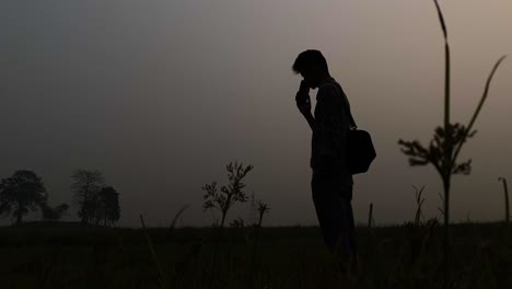 Silhouette-Of-Man-Using-Smartphone-At-Dusk---Rural-Telecommunication-Concept