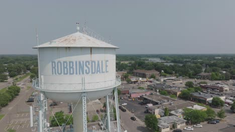 Drone-shot-capturing-water-tower-of-Robbinsdale-city-during-summer-afternoon-in-Minnesota,-USA