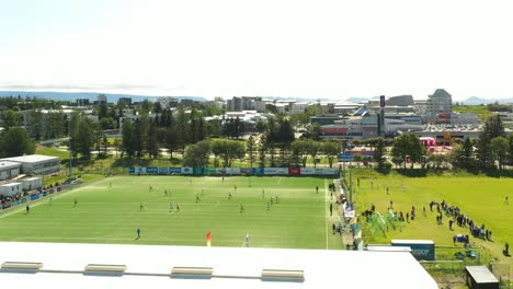 Soccer-football-tournament-at-a-stadium-in-an-urban-city,-Aerial-view