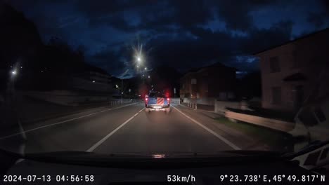 Driving-at-night-on-paved-streets-in-Italian-town-and-taking-exit,-dash-cam-footage