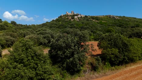 Aerial-revealing-shot-of-Château-Bas-d'Aumelas-surrounded-by-vineyards