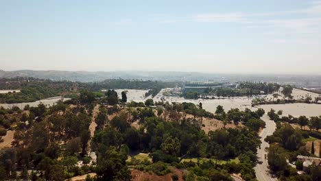 Aerial-wide-shot-of-Dodger-Stadium-in-Los-Angeles-with-parking-lots-during-sunny-day