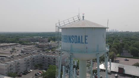 Aerial-pan-shot-of-water-tower-of-Robbinsdale-city-during-daytime-in-Minnesota,-USA