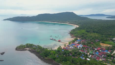 Panoramic-aerial-view-of-Koh-Rong-Island-beach-small-hamlet-with-magnificent-ocean-and-mountain-view