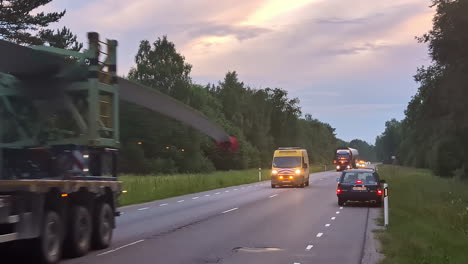 A-Transport-Truck-is-Being-Escorted-as-it-Makes-its-Way-Along-a-Rural-Highway---Static-Shot