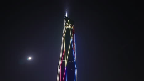 Moon-and-the-illuminated-Merdeka-118-tower,-night-in-Kuala-Lumpur,-Malaysia