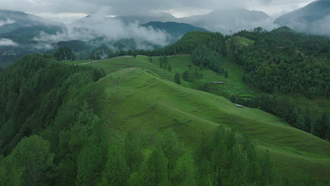 Drone-shot-of-the-vibrant-green-landscape-in-Makwanpur,-Nepal,-featuring-lush-trees,-rolling-hills,-and-greenery-under-a-cloudy-sky-picturesque-and-happening-tourist-area