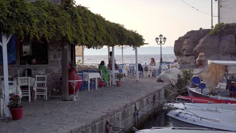 Tourists-in-luxury-tavern-on-tropical-beach-with-sea-background-on-Greek,-Lesvos-Island