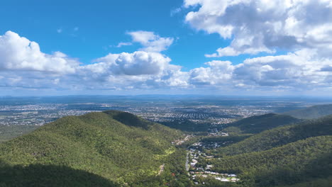 Flight-above-Rockhampton's-Mt-Archer-suburb-of-Frenchman's-Creek-cradled-in-the-dense-sub-tropical-forest-of-the-National-Park-and-views-to-the-vast-suburbs-of-the-city-and-plains-beyond-Australia