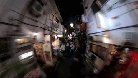 Night-time-lapse-of-a-busy-Golden-gai,-Shinjuku,-showing-crowds-and-neon-signs-with-small-old-bars