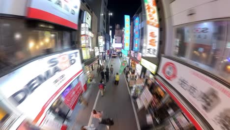 Night-time-lapse-of-a-bustling-Kabukico,-Shinjuku,-with-crowds-and-neon-lights