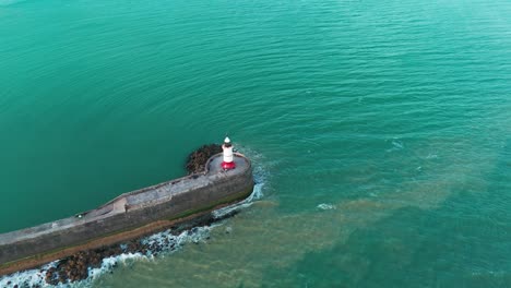 Based-on-a-concrete-foundation-a-lighthouse-is-shot-from-the-air