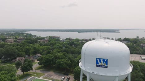 Aerial-shot-revealing-beautiful-landscape-with-water-tower-in-front