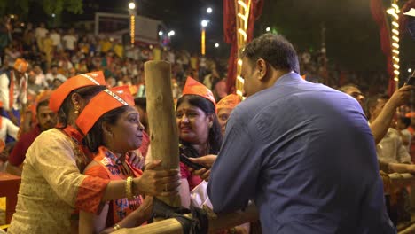 Indian-media-news-channel-field-reporter-and-journalist-taking-to-women-supporters-of-BJP-during-Lok-Sabha-election-campaign-public-rally-at-Assi-Ghat