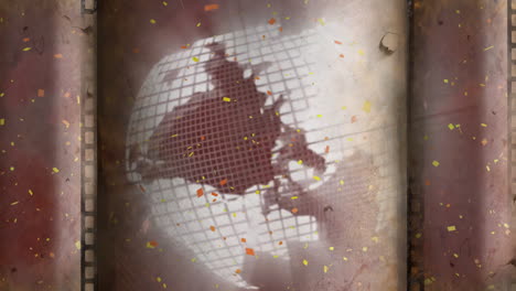 Confetti-falling-over-globe-on-rustic-background,-creating-festive-mood