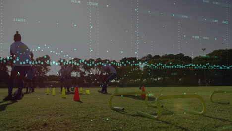 Data-points-and-graphs-animation-over-athletes-training-on-soccer-field