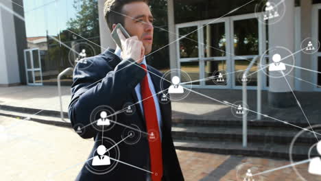 Talking-on-smartphone,-businessman-with-network-connections-animation-over-office-building