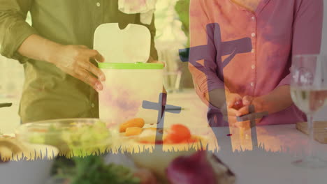 Preparing-food-in-kitchen,-cross-animation-over-people-chopping-vegetables