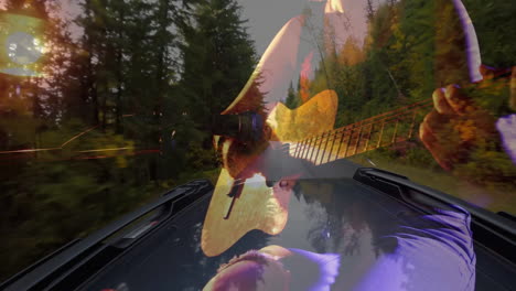 Playing-guitar-animation-over-scenic-forest-drive,-enjoying-nature''s-beauty