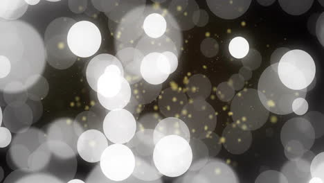 Bokeh-lights-and-golden-particles-animation-over-dark-background