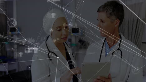 Doctors-discussing-patient-data-on-tablet-with-medical-network-animation